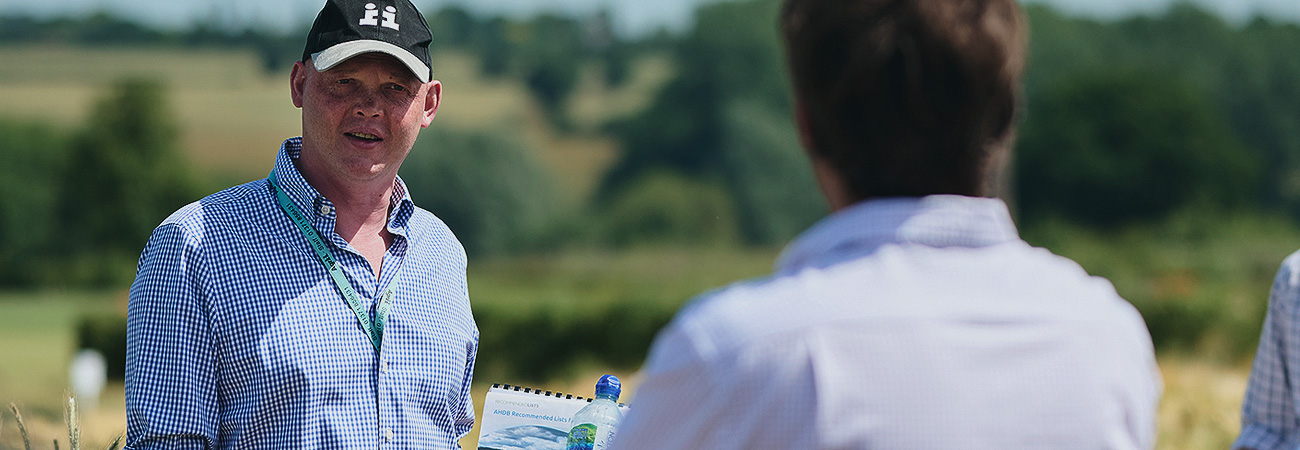 Seed Technical Manager Discussing Crop Varieties and Genetics with Farmers