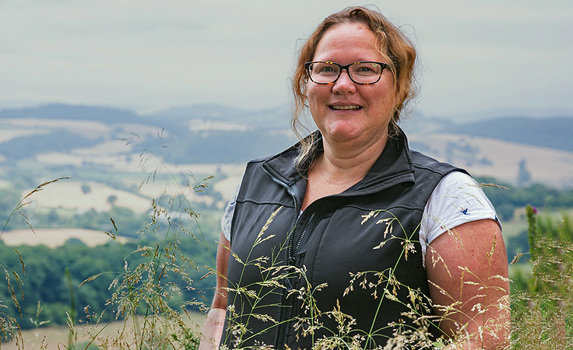 Agrii livestock Advisor in field with hills and landscape background