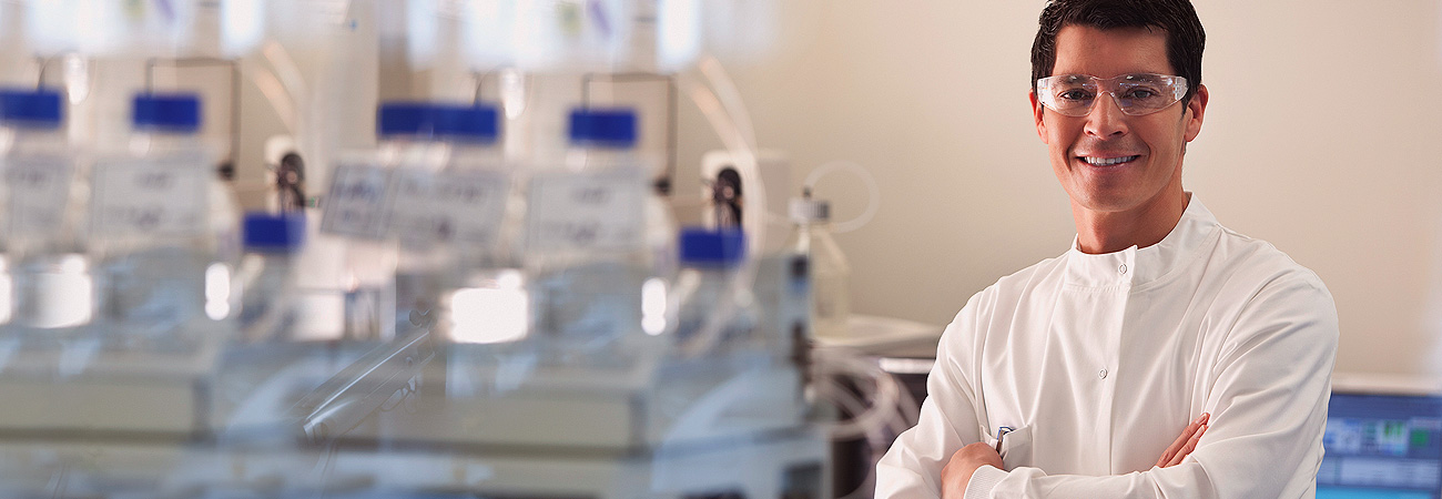 Lab Technician in labaoatory with overalls and protective eyewear