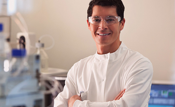 Lab Technician in labaoatory with overalls and protective eyewear